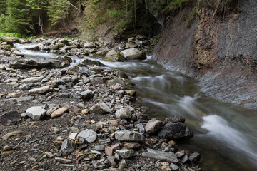 The cold water of a mountain river in summer