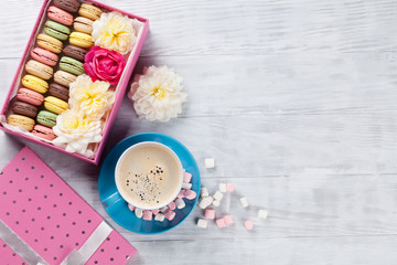 Macaroons and coffee. Sweet macarons in gift box