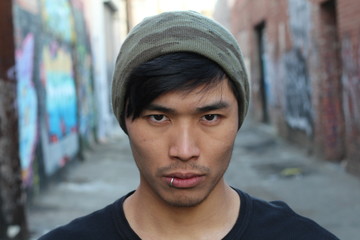 Asian man with piercing and beanie
