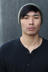 Asian man with lip ring and beanie