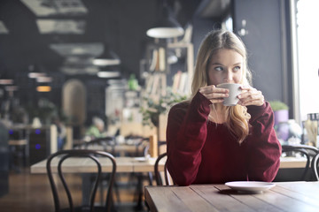 Blonde girl having coffee 