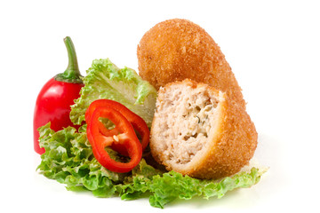 two fried breaded cutlet with lettuce and pepper isolated on white background