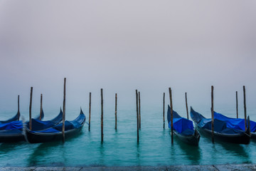 Fototapeta na wymiar Foggy Daybreak in Venice, with Gondolas
