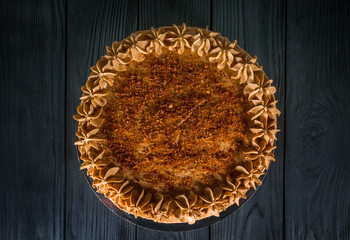 Delicious cake on a wooden black background