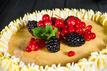 Delicious cake on a wooden black background
