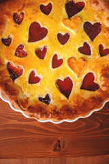 strawberry cake for Valentine's Day with hearts on a wooden background