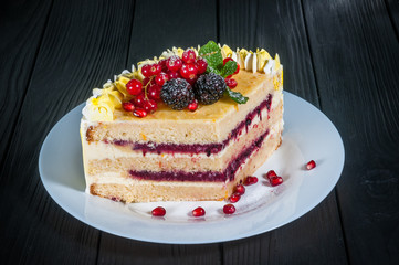 Delicious cake on a wooden black background