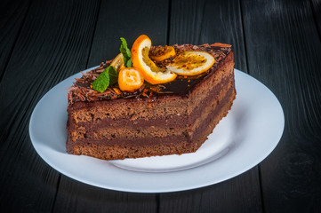 Delicious cake on a wooden black background
