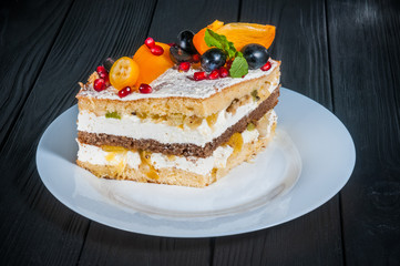 Delicious cake on a wooden black background