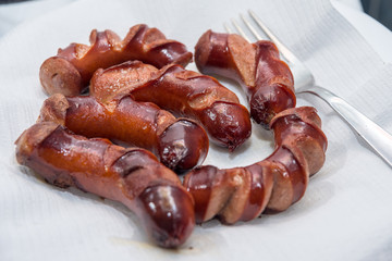 juicy grilled sausages in a pan