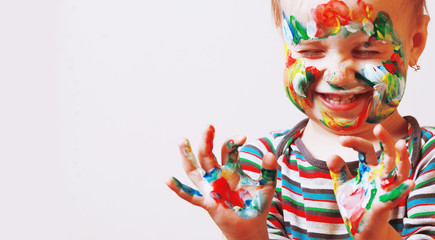 Happy cute little girl with colorful painted hands