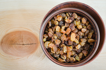 Dried Organic Raisin in Bowl on Wooden BackgroundClose-up.