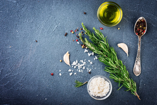 Herbs and spices on dark background. Top view. Rosemary  bunch and spices.