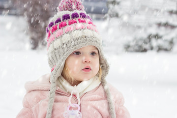 Portrait of a toddler girl on the snow