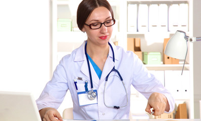 Young woman doctor examines the X-rays. Isolate