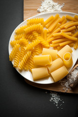 three types of italian pasta on a white plate