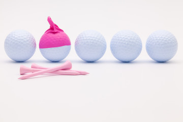 White golf balls with funny cap on the white background.