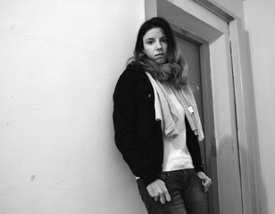 A female model in black and white waiting near the elevator