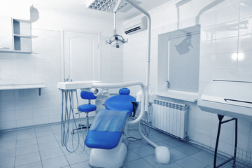 Professional tools and chair in modern dentist room