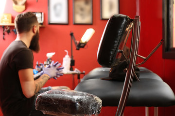 Professional tattoo master workplace in salon, close up view