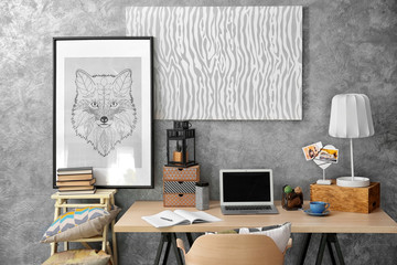 Workplace with laptop on table in modern room