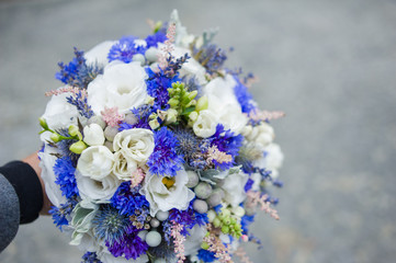 Big wedding bouquet before ceremony. Bride hands. 
