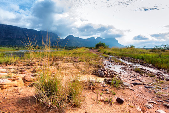 Dirt and rocky road on shallow river bed in Entabeni, South Afri