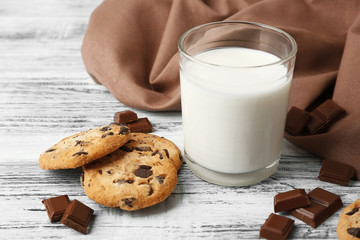 Chocolate cookies and napkin on wooden background