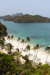 Two motorboats and few people at a beach on the Koh Wua Talab island at the Angthong (Ang Thong) National Marine Park in Thailand, viewed from above.