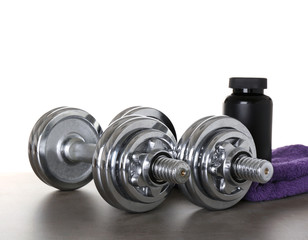 Sports concept. Workout objects on grey table and white background