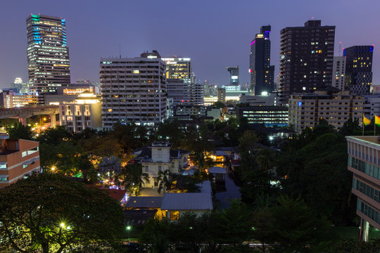 View of skyscrapers and other buildings in Bangkok, Thailand in the evening.