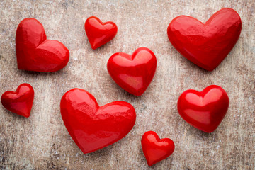 Red heart on the wooden background.