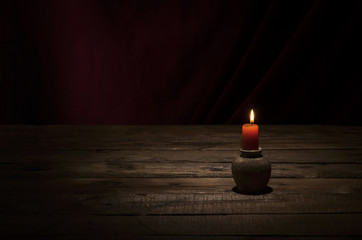 Candle on wooden table.