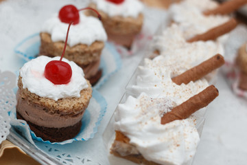 Dessert with chocolate mousse and whipped cream with cherry on t
