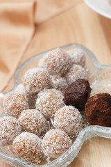Truffles and chocolate balls with coconut flakes