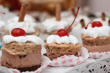 Dessert with chocolate mousse and whipped cream with cherry on t