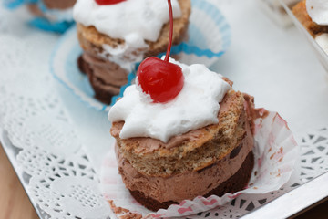 Dessert with chocolate mousse and whipped cream with cherry on t