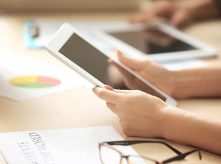 Businesswoman holding tablet during meeting in office