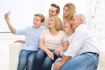 Happy family taking selfie in living room