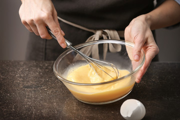 Young woman cooking in kitchen, closeup