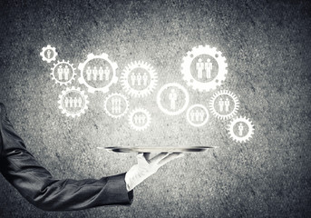 Waiter hand with white gloves holding silver plate full of social media communication icons