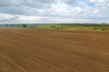 Fototapeta na wymiar Agircutural field with brown soil