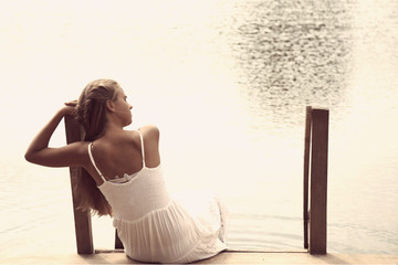 Relaxation. beautiful young girl resting on the lake