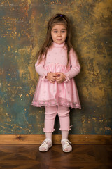 Pretty little brunette girl posing in the Studio
