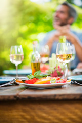 Close-up on a plate of tomato salad on a wooden table