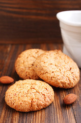 Obraz na płótnie Canvas Almond cookie on a brown wooden background
