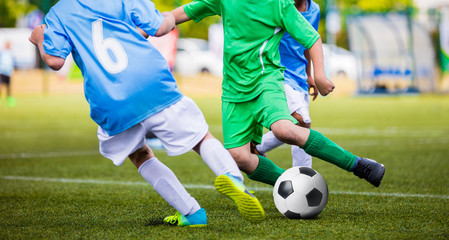 Soccer Football Match. Young Boys Kicking Football Ball on the Sports Field. Kids Playing Soccer Tournament Game on the Pitch