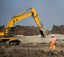 Excavator working at road construction site