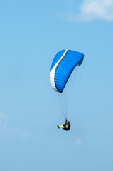 Paraglider flying in the sky on a paraglider. Paragliding.