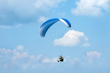 Paraglider flying in the sky on a paraglider. Paragliding.